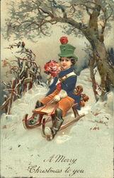 A little boy riding holding with beautiful flowers in a snow Postcard