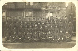 Group of Men posing outside building Postcard