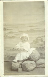 Portrait of Child with Seascape Behind, holding a Spade Postcard