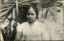 Young woman standing in field Postcard