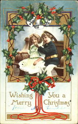 A boy and girl sitting on a bench Postcard