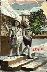 Two girls in the snow with present and Christmas Tree Postcard