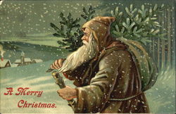 Santa in a brown robe carrying a tree in the snow Santa Claus Postcard Postcard