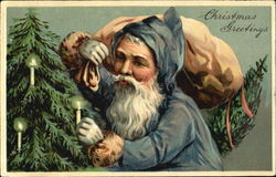 Santa in blue robe placing candle on tree Santa Claus Postcard Postcard