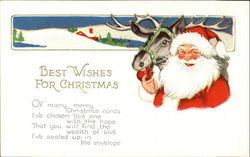 Santa feeding an apple to a reindeer Postcard