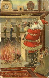 Santa hanging stocking before a fire Postcard