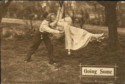 Man pushing woman in swing Postcard