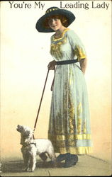 Lady in hat with dog on leash Postcard