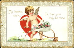 Cupid pushin flowers in a wheel barrel Postcard