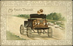 Two cupids driving away in a coach Postcard