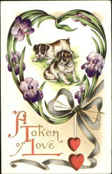 Two puppies surrounded by heart of leaves and flowers Postcard