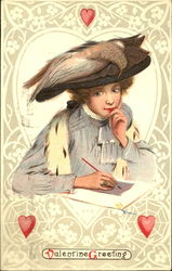 Woman in big brown hat with bird on it, writing Postcard