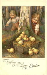 Two chilcren looking at a box with chicks Postcard