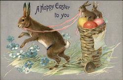 Bunny Pulls Two Baby Bunnies in a Basket of Eggs Postcard