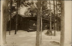 A Cabin Amidst Snow and Trees Postcard