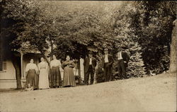 Family Portrait By Trees Outside House Postcard