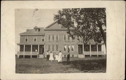 Old boarding house with people in front yard Postcard