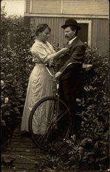 Woman puts Corsage on Man Bicycles Postcard Postcard