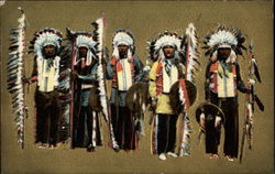 Five Native American chiefs in full regalia and feathered headdresses Postcard