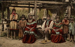 Family of Seminole Indians near a chickee (home) Florida Native Americana Postcard Postcard