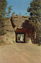 View of Mt. Rushmore through iron Mt. road tunnel Postcard