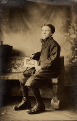 Young boy sitting at portrait session Postcard