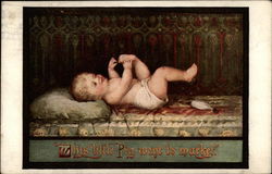 Baby playing with its toes Postcard