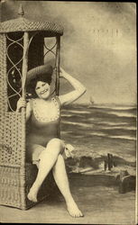 Girl in wicker chair at beach Postcard