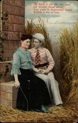 Couple sitting in hay field Postcard