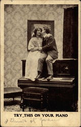 Courting couple sit on top of an upright piano Postcard