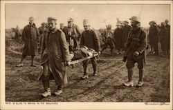 Soldiers taking injured off battlefield World War I Postcard Postcard