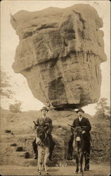 Two men on mules at Balanced Rock, 1911 Postcard