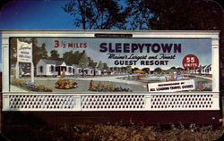 Signboard approaching Sleepytown Guest Resort Postcard