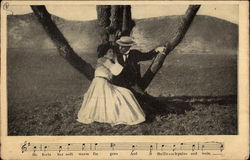 Man and Woman Sitting In Tree Postcard