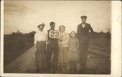 Family Standing on the Train Tracks Postcard