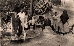 African scene of villagers getting water from well Postcard