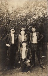 Four Men Posing Postcard