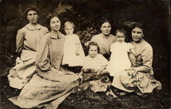 Family posing on Grass Postcard