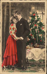 Couple Embracing by a Candle-lit Christmas Tree Postcard