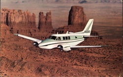 The Beechcraft Queen Air A80 over Monument Valley, UT Postcard