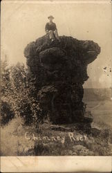 Man Sitting on Top of Chimney Rock Wisconsin Dells, WI Postcard Postcard