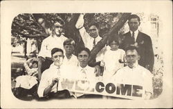 Welcome Sign Held by Family Members Postcard