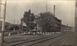 Train Station with Flags Flying Postcard