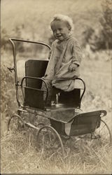 Baby Standing in Baby Carriage Postcard