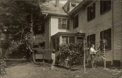 Snapshot of Men Stringing Vines Postcard