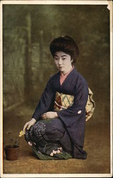 Geisha Girl Kneeling beside Flower Pot Asian Postcard Postcard