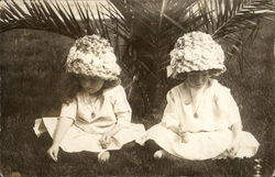 Two Girls, Fancy Hats, Sitting in Grass Children Postcard Postcard