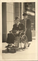 Woman Pushing a Man in a Wheelchair Postcard