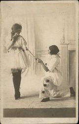 A Person on their Knee talking to a Woman Pierrot? Postcard