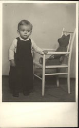 Vintage Photograph of Young Boy standing beside Chair with Teddy Bear Postcard